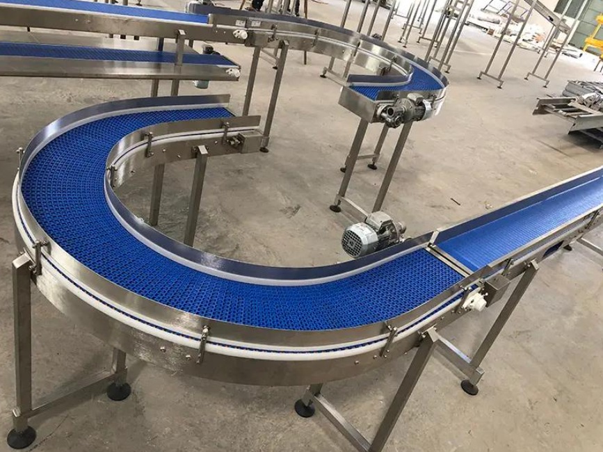 Blue modular conveyor belt curving through a facility